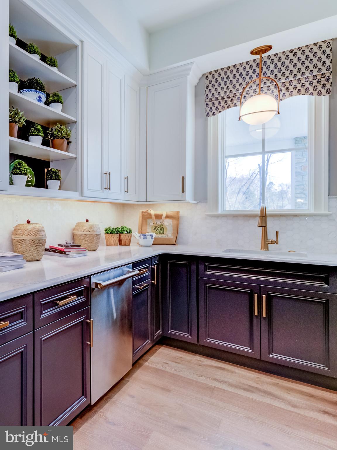 319 Iven Avenue Wayne, PA 19087 - Photo 22 of 44 a kitchen with stainless steel appliances granite countertop a sink dishwasher and cabinets with wooden floor