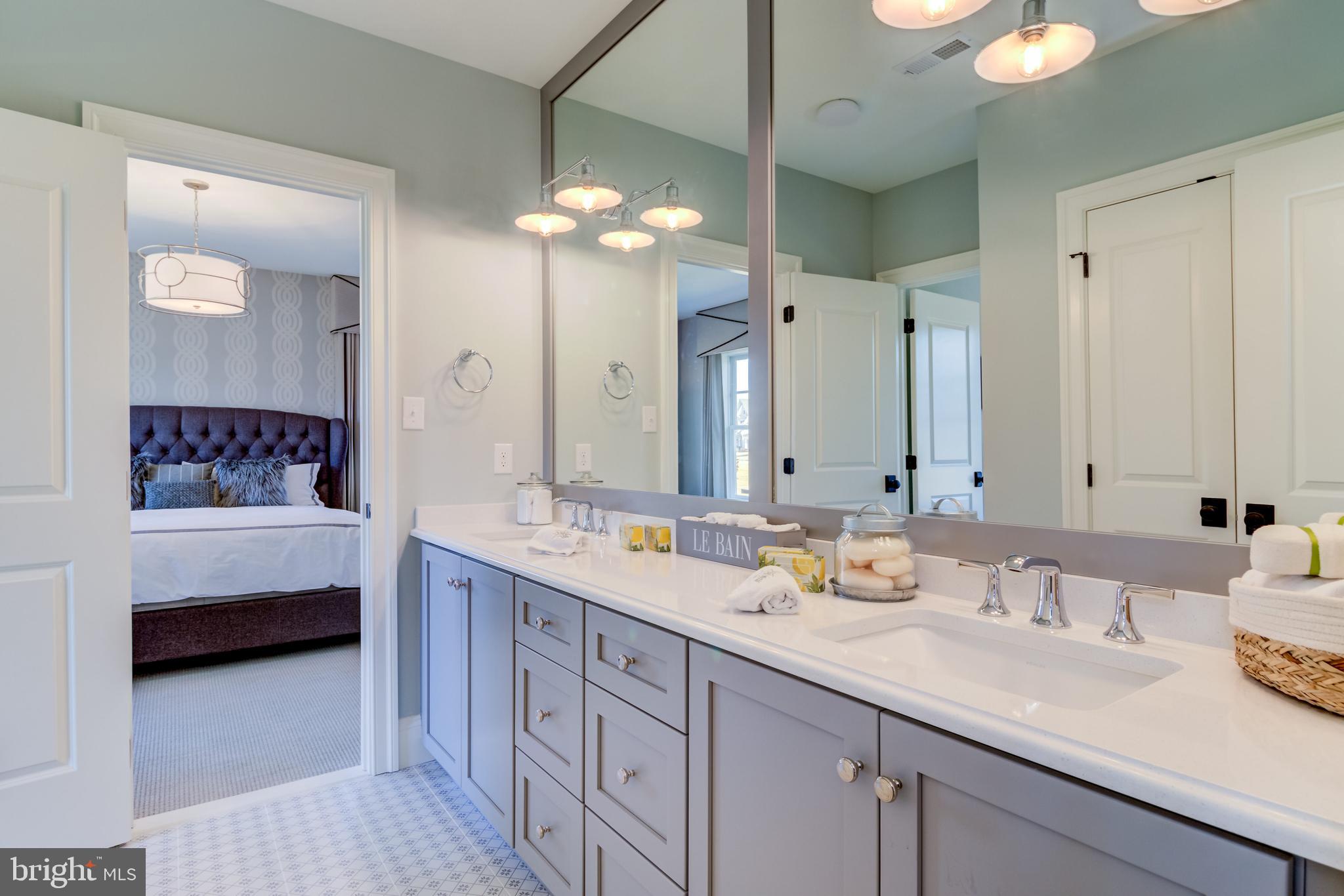 319 Iven Avenue Wayne, PA 19087 - Photo 31 of 44 a bathroom with double vanity sinks a vanity a lamp and a mirror