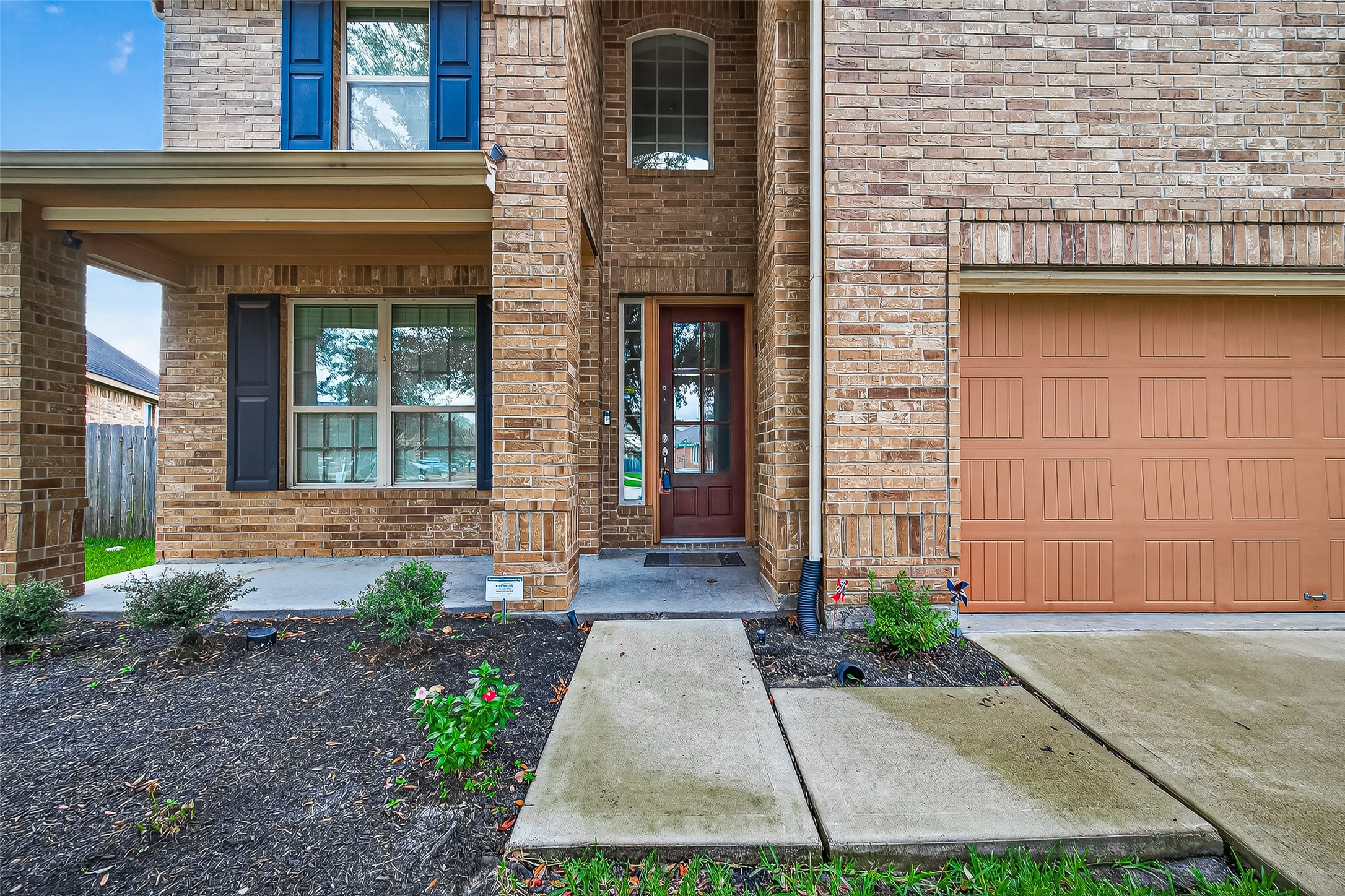 8107 Lockridge Terrace Lane Cypress, TX 77433 - Photo 5 of 50 Get ready to fall in love before you even step inside. This home greets you with a warmth and charm that's simply irresistible. The deep, covered front porch invites you to pause and relax, offering a lovely, sheltered space for a bistro set or rocking chairs. Paired with the timeless all-brick facade and a front door that lets in the light, this entry feels like a true embrace. It’s the perfect welcome home, every single day.