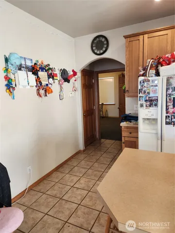 a bedroom with a bed and a refrigerator