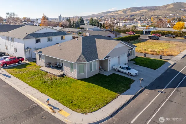 an aerial view of residential houses with outdoor space and river