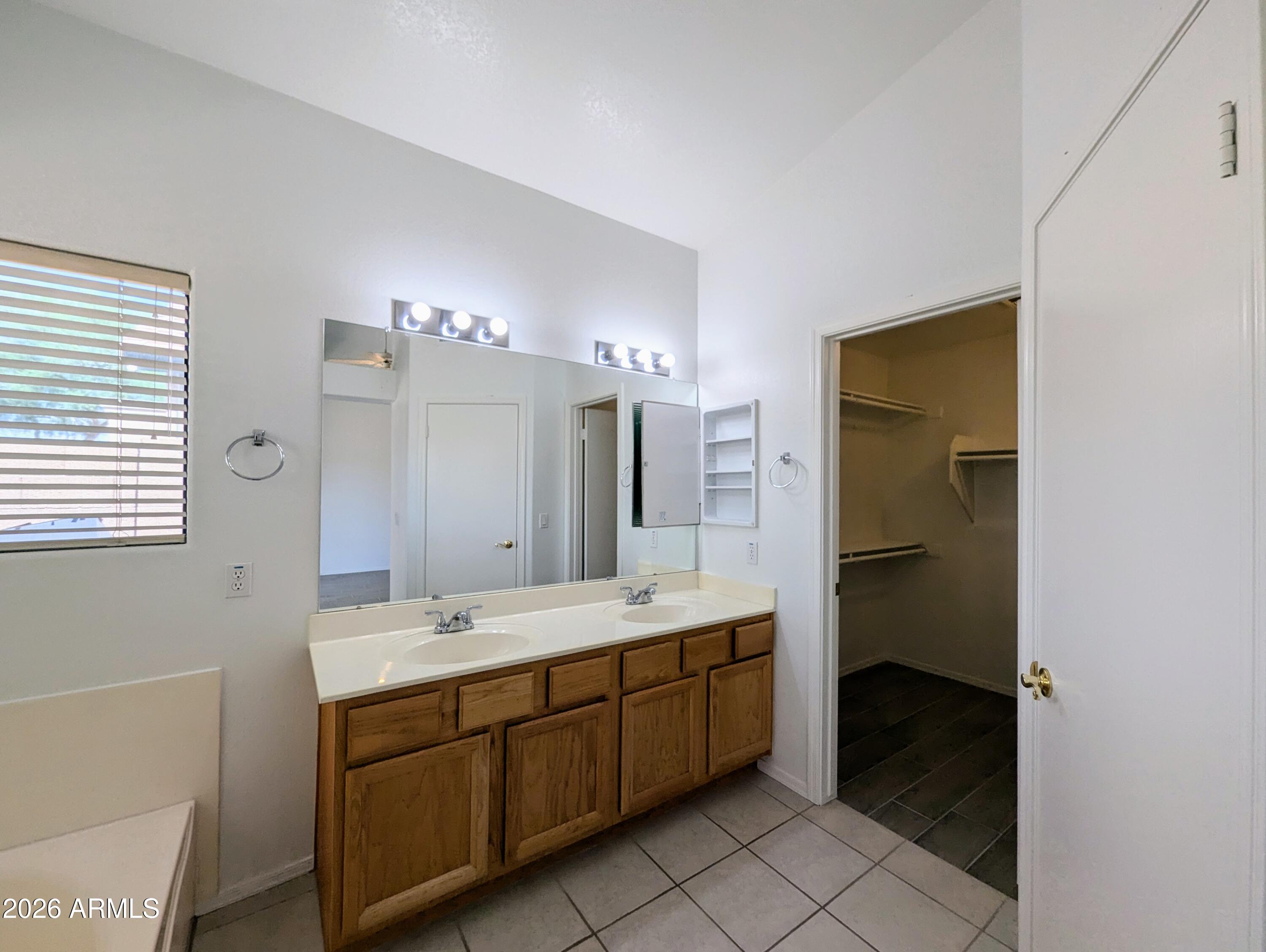 5424 West Wagoner Road Glendale, AZ 85308 - Photo 21 of 37 a spacious bathroom with a double vanity sink a mirror and a bathtub