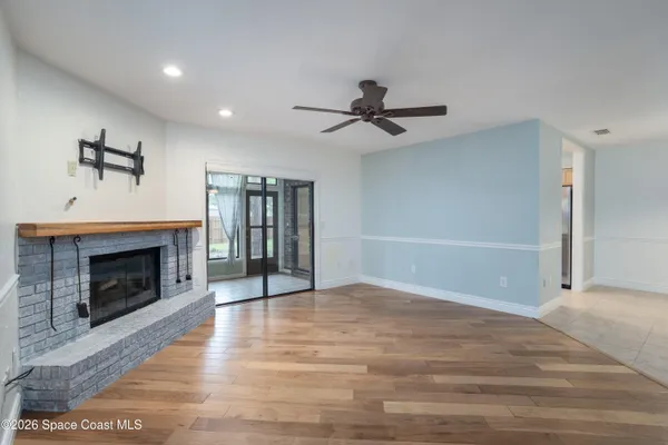 a living room with fireplace furniture and a large window