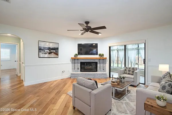 an empty room with wooden floor a fireplace