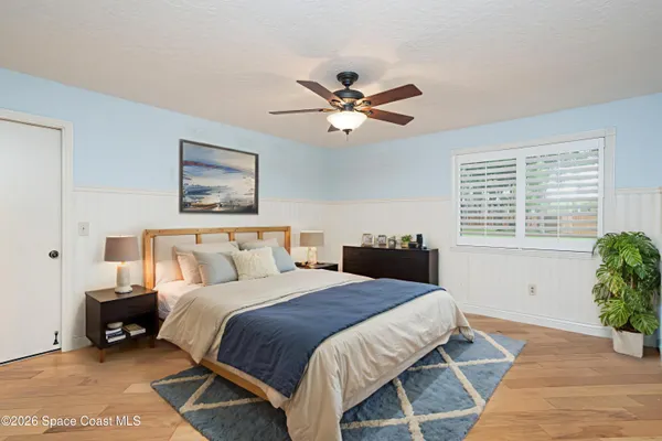 a view of a room with a ceiling fan and a window