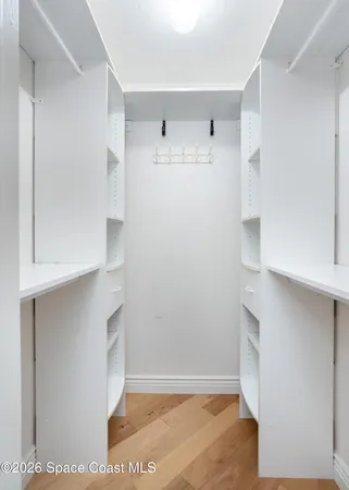 a bedroom with a bed and a ceiling fan