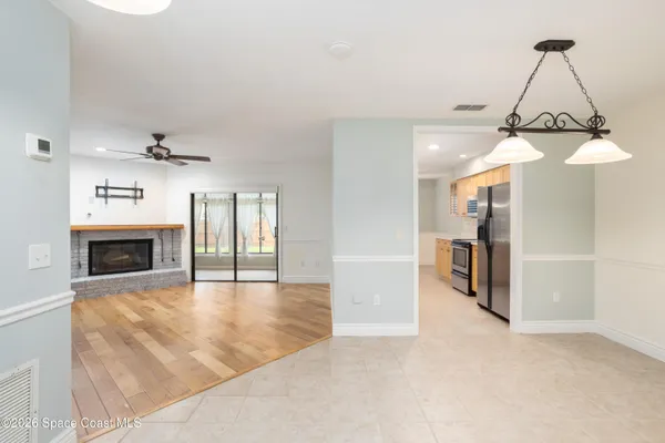 a dining room with furniture wooden floor a rug and a chandelier
