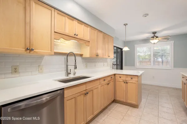a kitchen with granite countertop a refrigerator stove and microwave