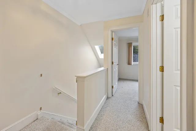 a view of a hallway with white walls