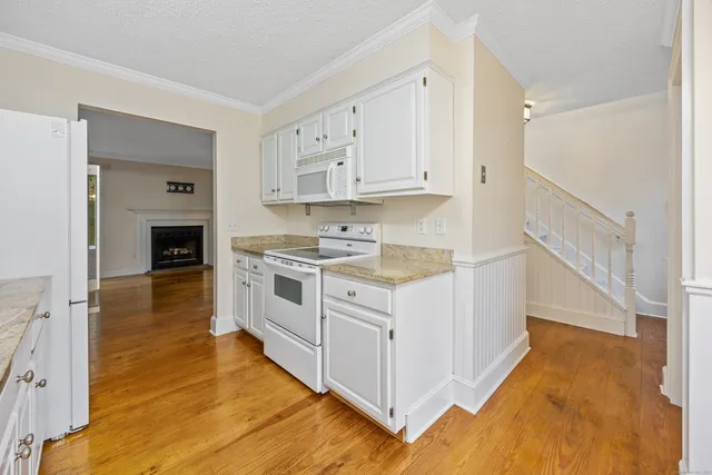 a kitchen with stainless steel appliances granite countertop a stove and a refrigerator