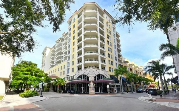 a view of a tall building next to a road