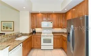 a kitchen with a sink stove and refrigerator