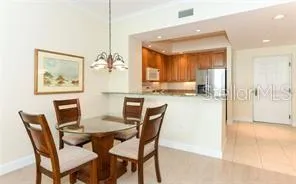 a view of a dining room with furniture and a chandelier