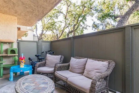 a outdoor space with a couch and a potted plant