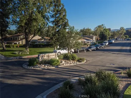 a view of a house with a yard and tree s