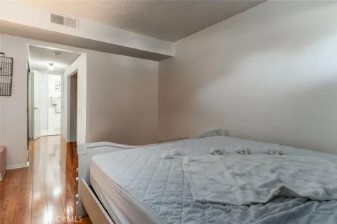 a view of a hallway with wooden floor and entryway