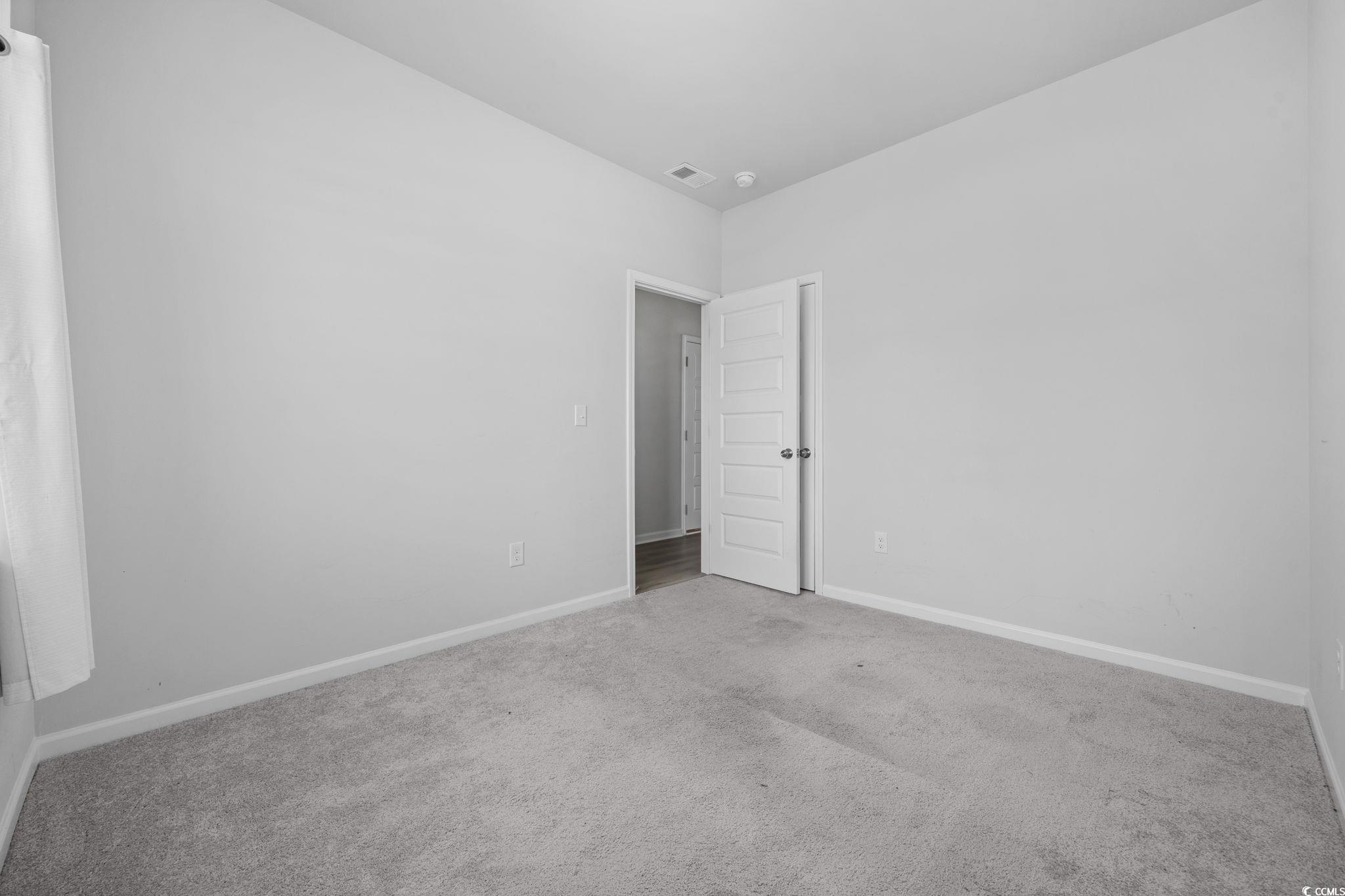 608 Sea Sparrow Street, Unit 608 Myrtle Beach, SC 29588 - Photo 19 of 37 Unfurnished room featuring carpet and baseboards