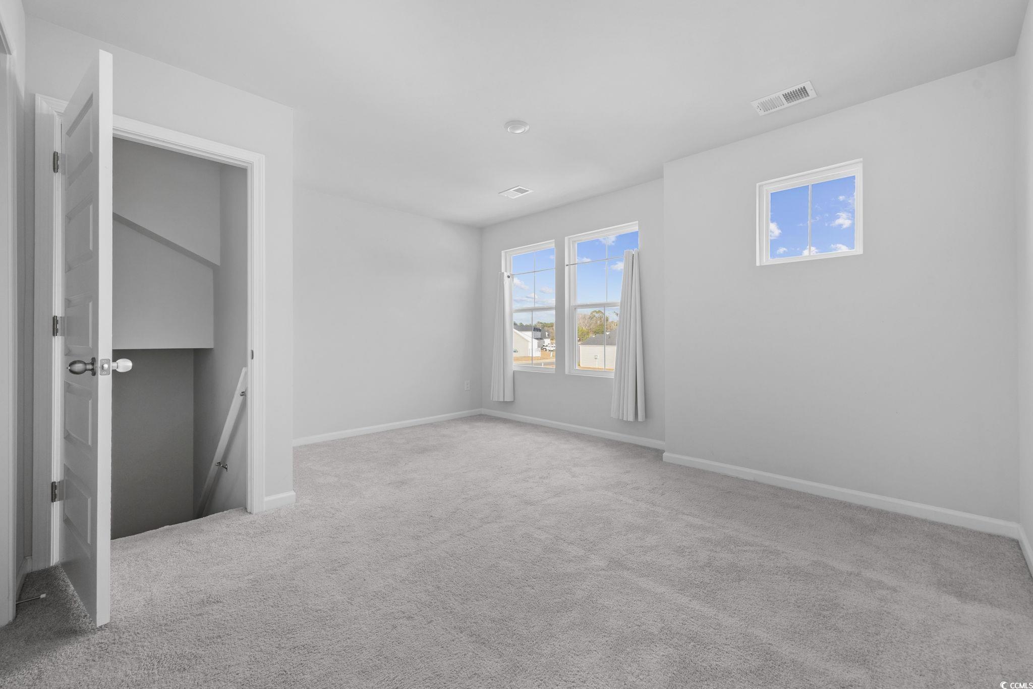 608 Sea Sparrow Street, Unit 608 Myrtle Beach, SC 29588 - Photo 21 of 37 Unfurnished bedroom featuring light carpet and baseboards