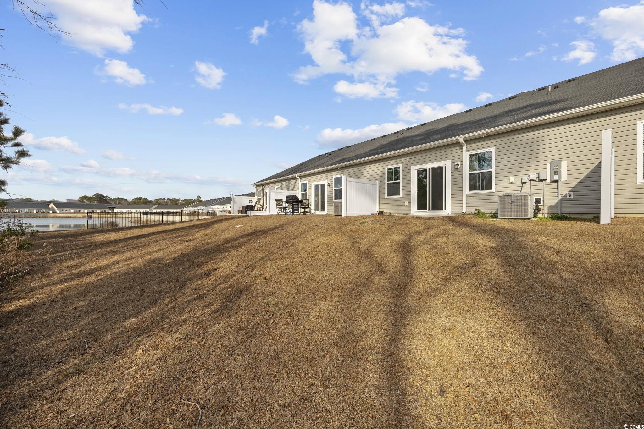 608 Sea Sparrow Street, Unit 608 Myrtle Beach, SC 29588 - Photo 26 of 37 Rear view of house featuring a lawn