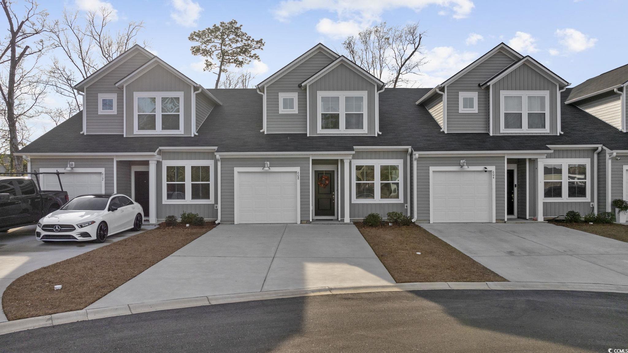 608 Sea Sparrow Street, Unit 608 Myrtle Beach, SC 29588 - Photo 36 of 37 View of front of property with driveway, a shingled roof, and a garage