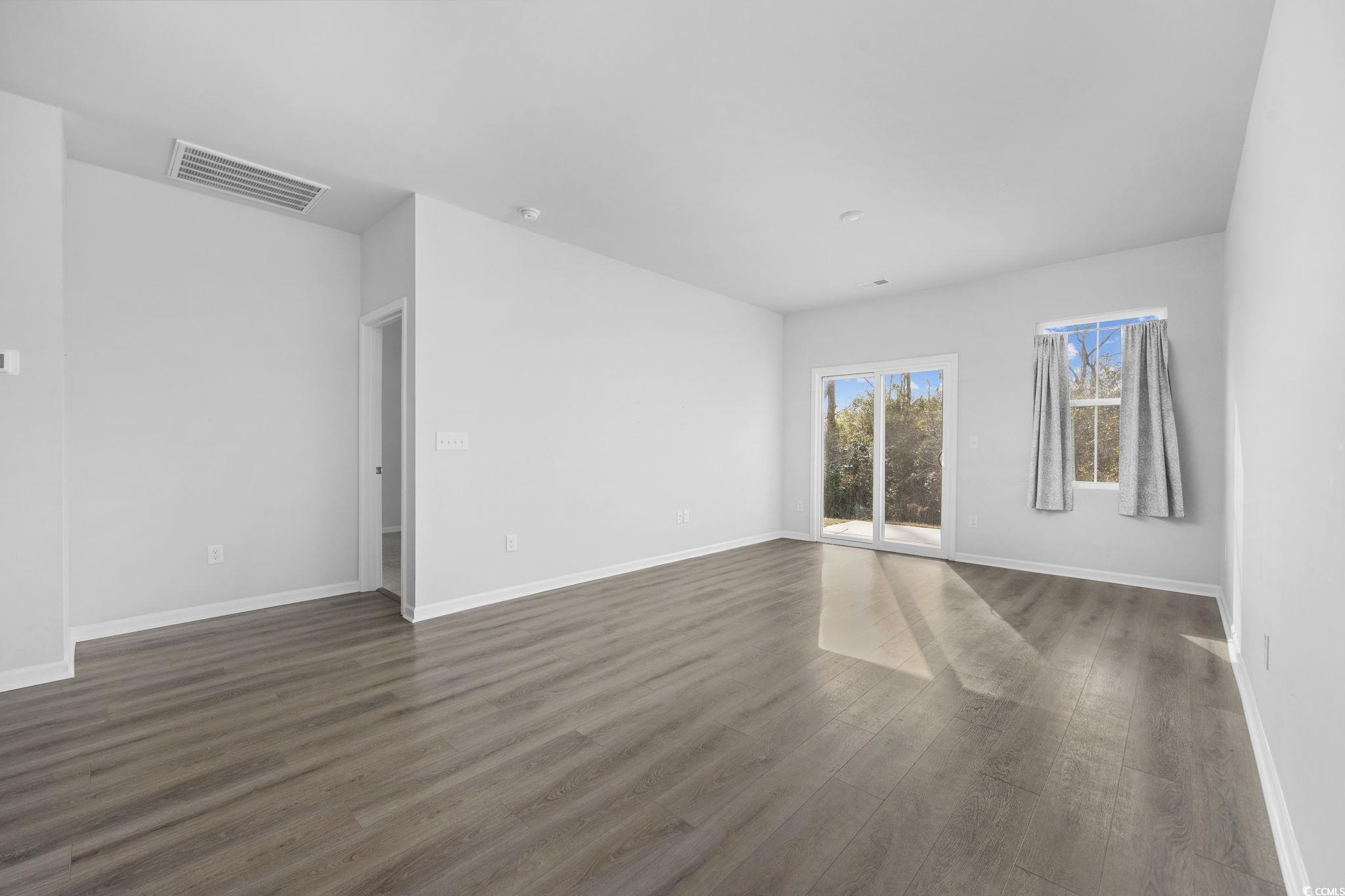 608 Sea Sparrow Street, Unit 608 Myrtle Beach, SC 29588 - Photo 4 of 37 Empty room with dark wood-type flooring and baseboards
