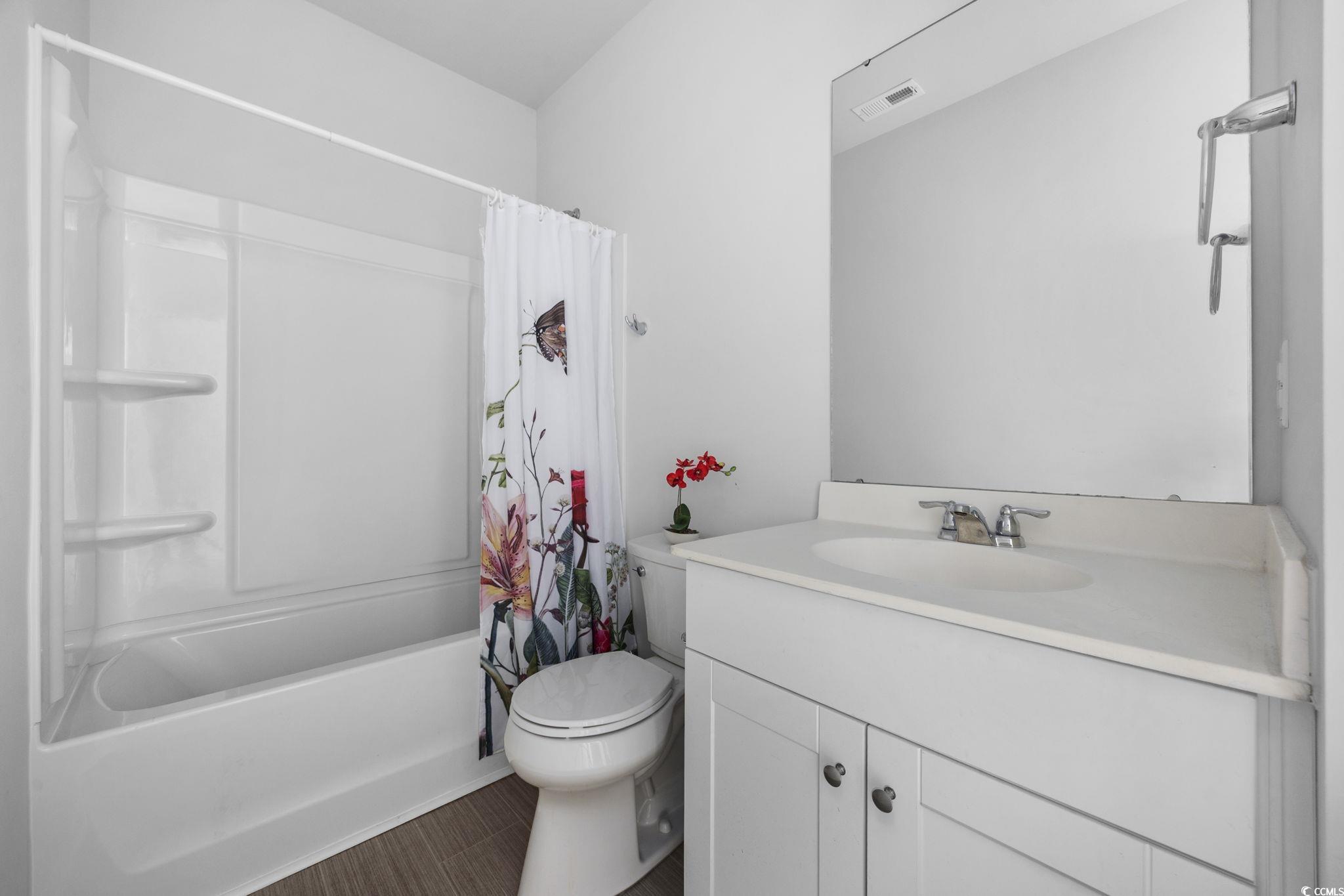 608 Sea Sparrow Street, Unit 608 Myrtle Beach, SC 29588 - Photo 5 of 37 Bathroom featuring shower / bath combo with shower curtain and vanity