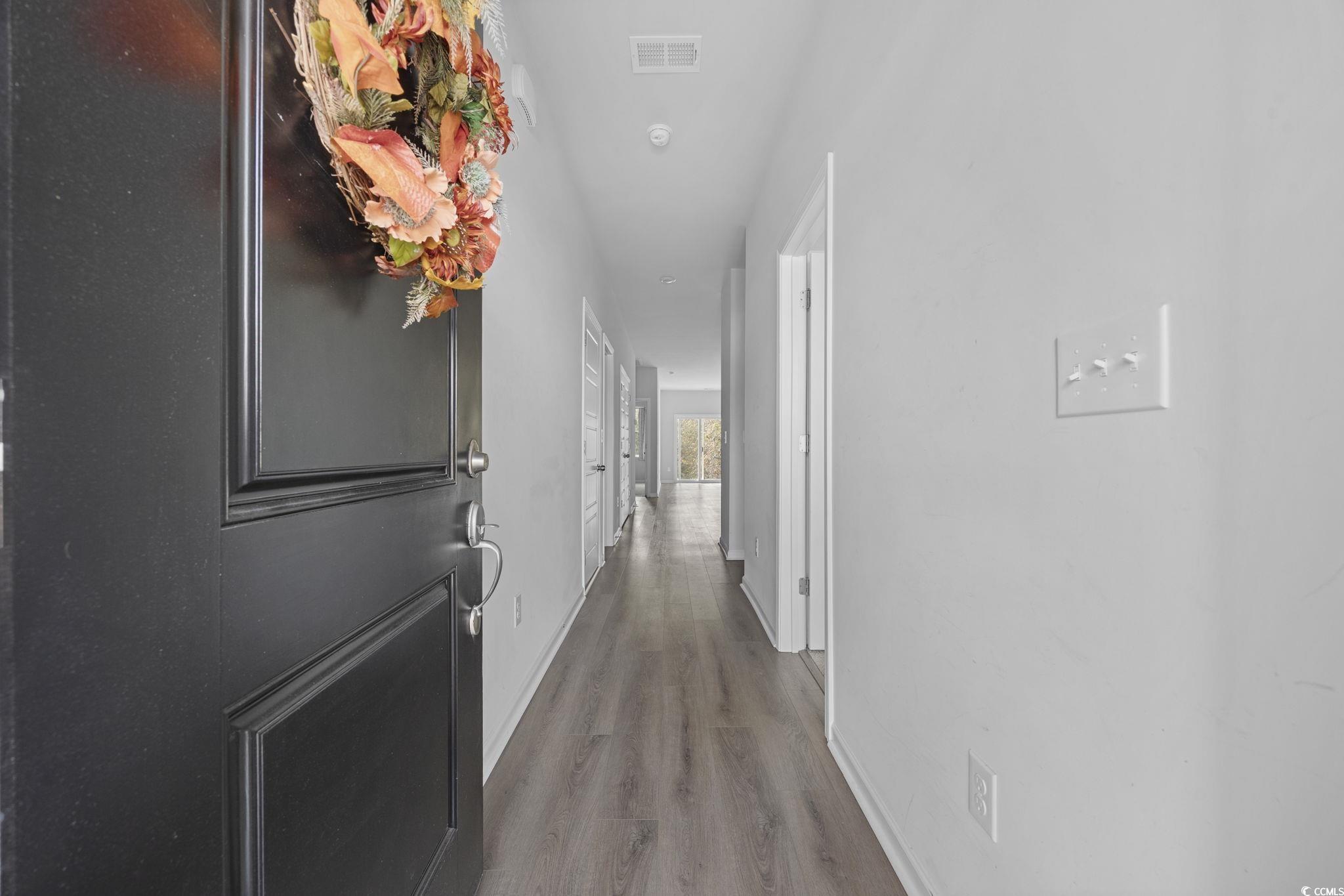 608 Sea Sparrow Street, Unit 608 Myrtle Beach, SC 29588 - Photo 6 of 37 Hallway with baseboards and wood finished floors
