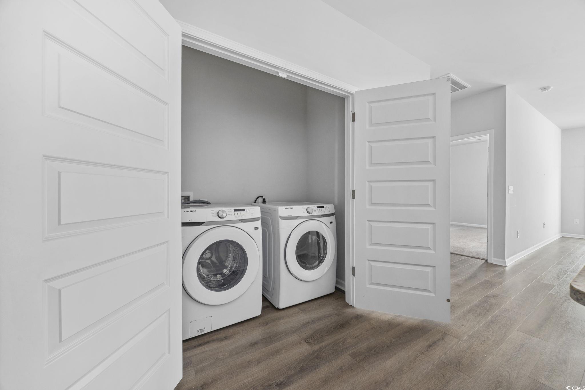 608 Sea Sparrow Street, Unit 608 Myrtle Beach, SC 29588 - Photo 10 of 37 Laundry room with dark wood-style floors and washing machine and clothes dryer