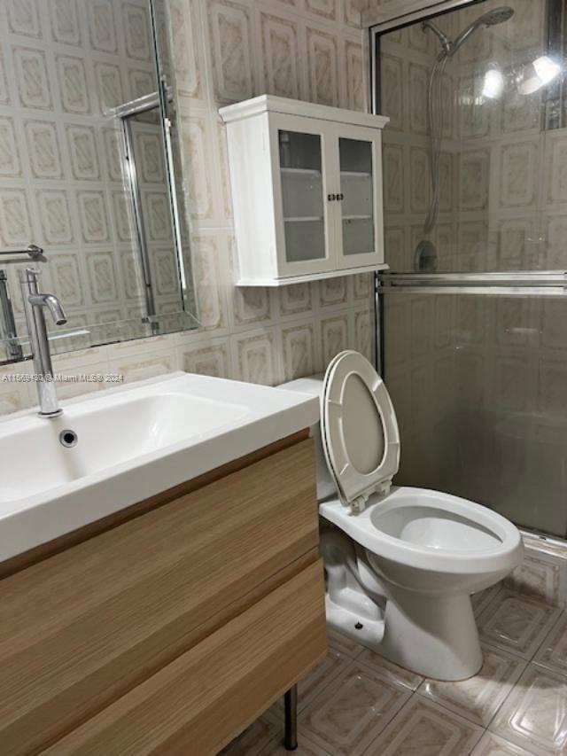 19260 Franjo Road Cutler Bay, FL 33157 - Photo 16 of 18 a bathroom with a toilet a sink and mirror