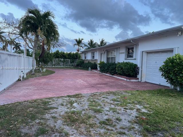 19260 Franjo Road Cutler Bay, FL 33157 - Photo 2 of 18 a view of a brick house with a yard and palm trees