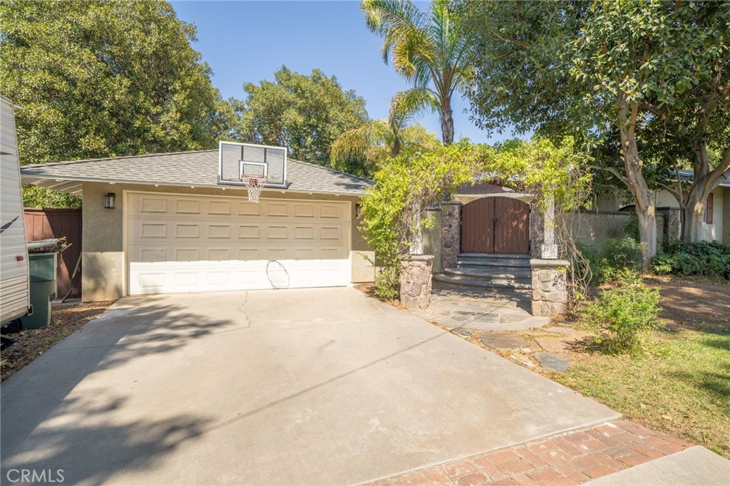 1995 Rincon Avenue Riverside, CA 92506 - Photo 3 of 18 a front view of a house with a yard and garage