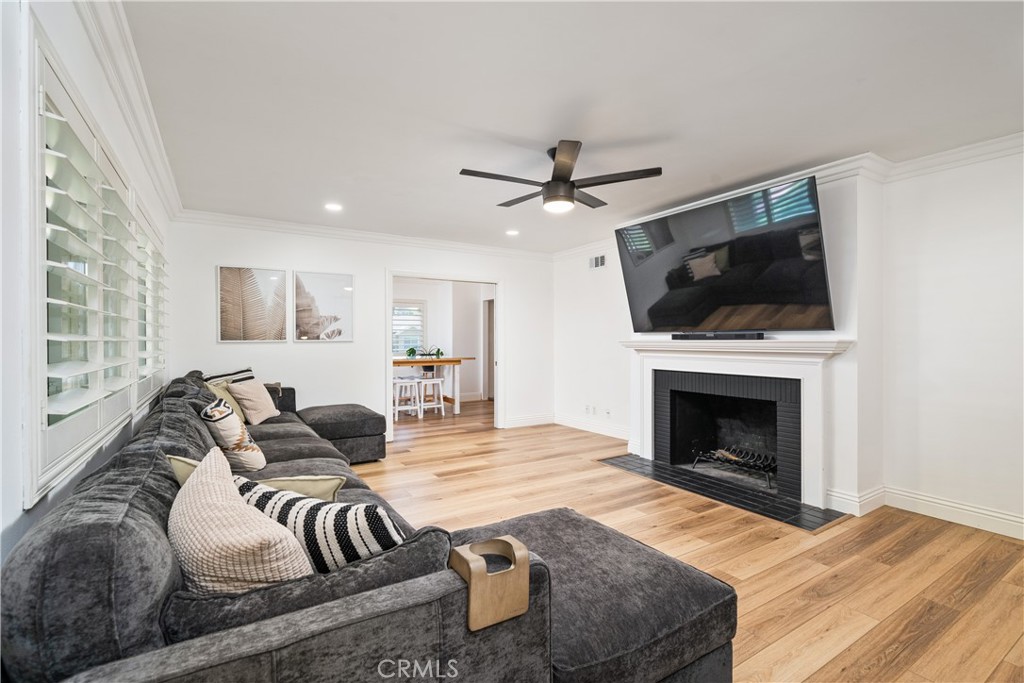1995 Rincon Avenue Riverside, CA 92506 - Photo 5 of 18 a living room with furniture a fireplace and a flat screen tv