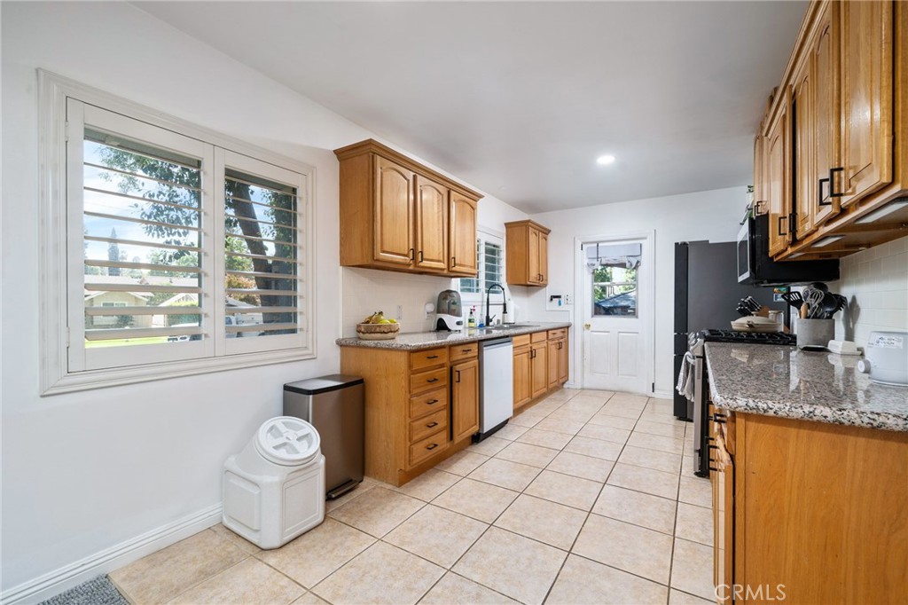 1995 Rincon Avenue Riverside, CA 92506 - Photo 7 of 18 a kitchen with stainless steel appliances granite countertop a stove sink and cabinets