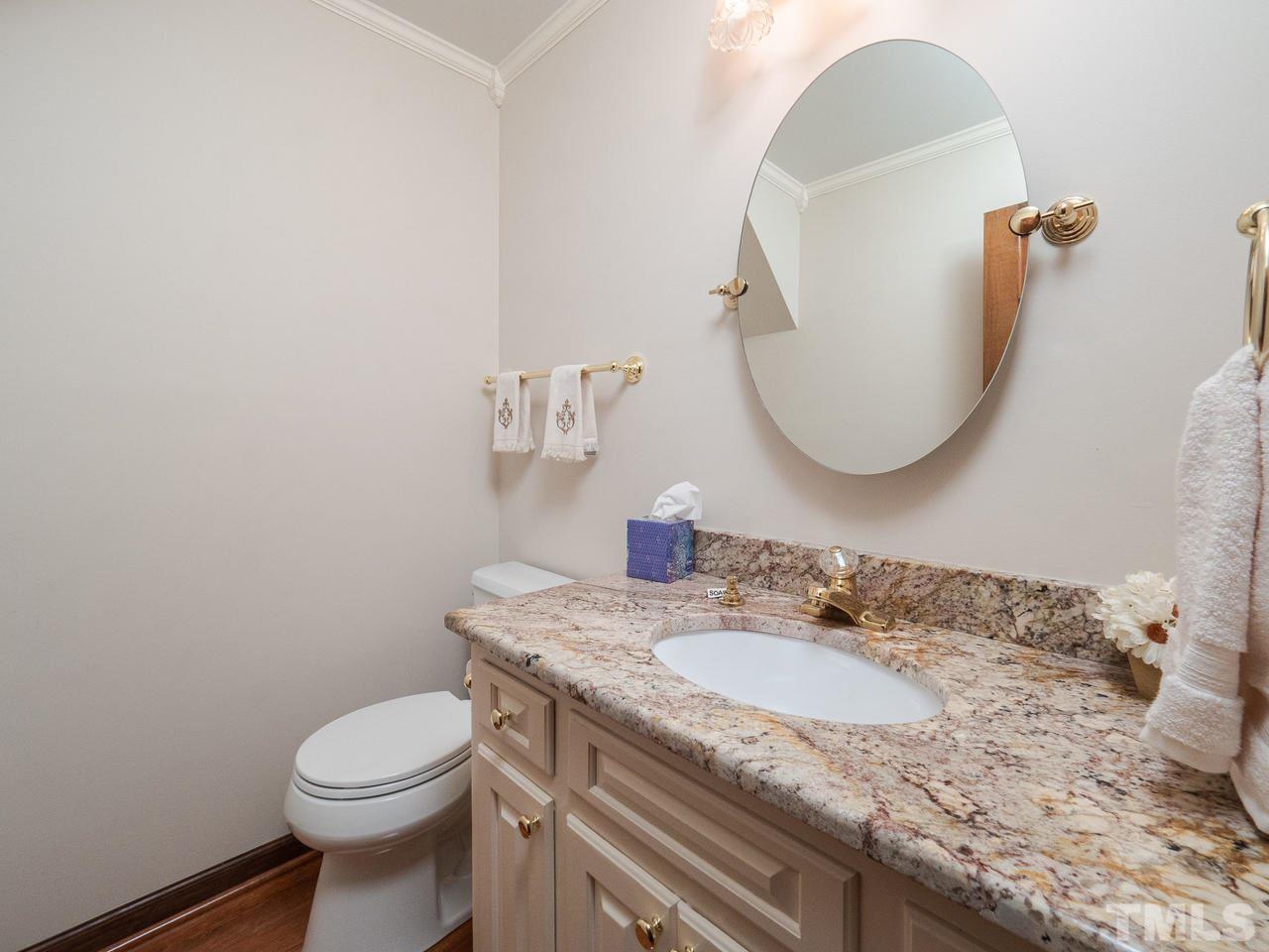 7705 Valley Run Drive Raleigh, NC 27615 - Photo 11 of 27 a bathroom with a granite countertop sink and a mirror