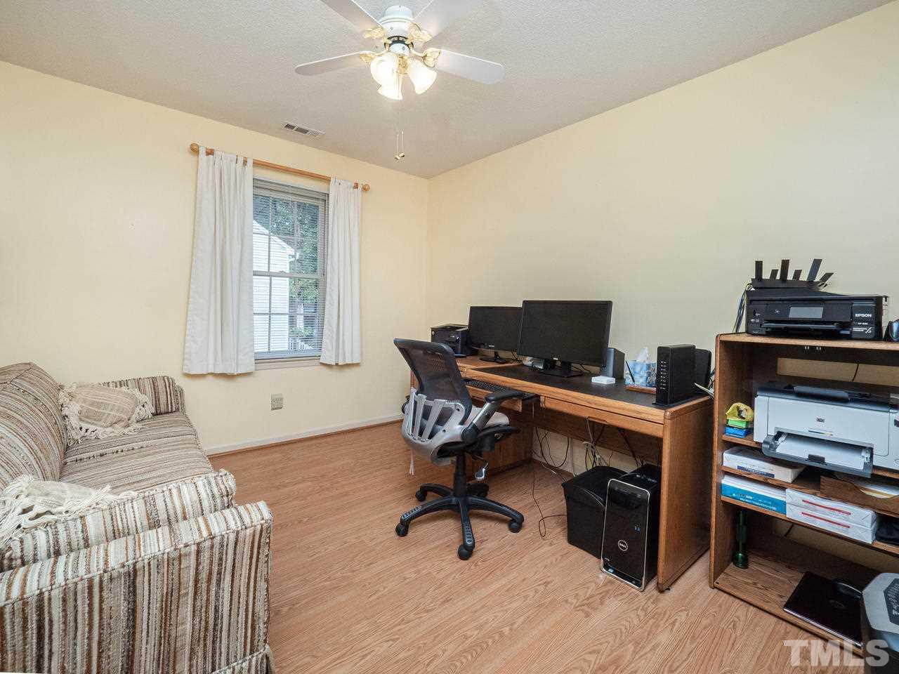 7705 Valley Run Drive Raleigh, NC 27615 - Photo 14 of 27 a view of a livingroom with workspace and a window