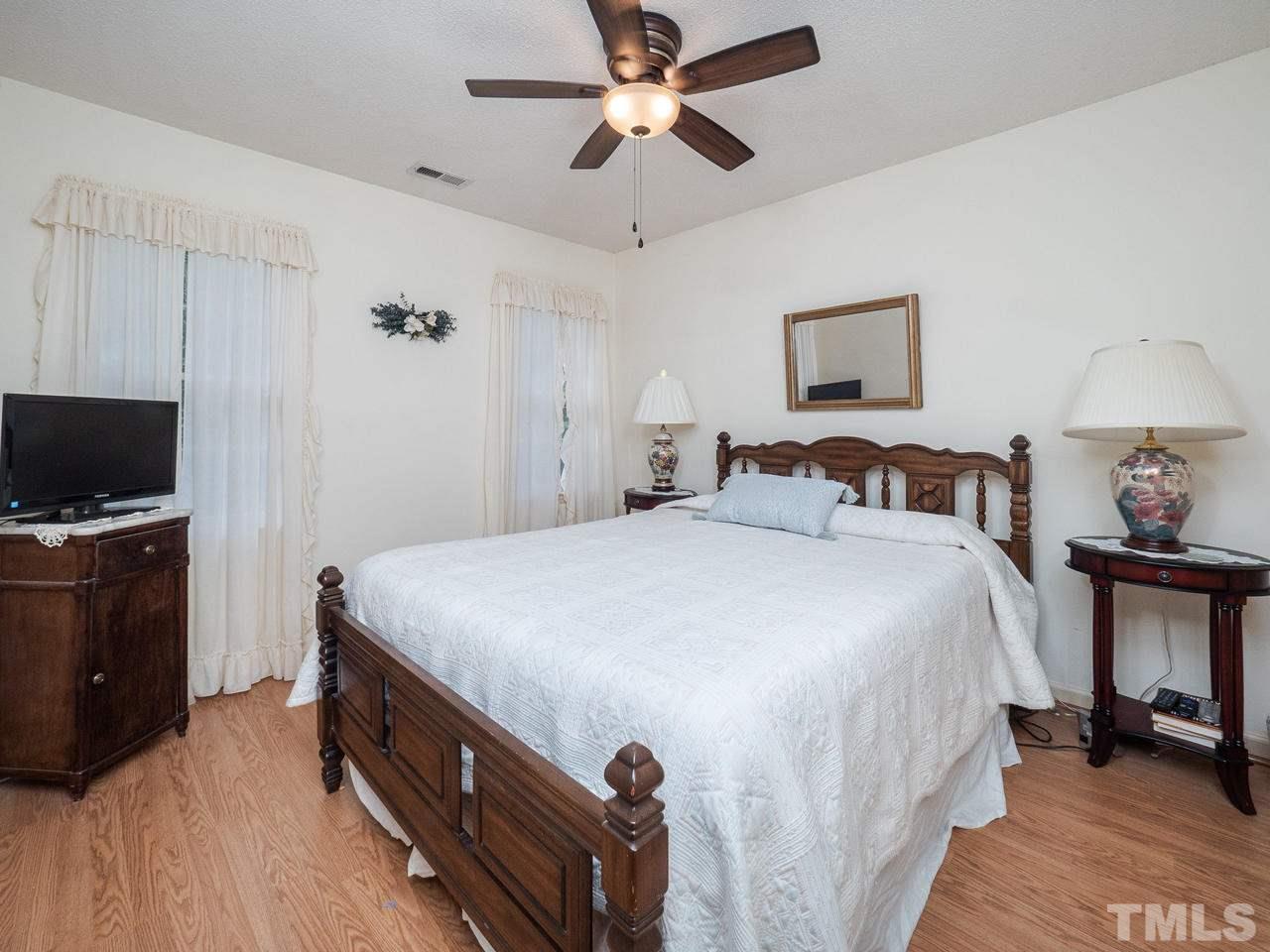 7705 Valley Run Drive Raleigh, NC 27615 - Photo 15 of 27 a bedroom with a bed and a tv