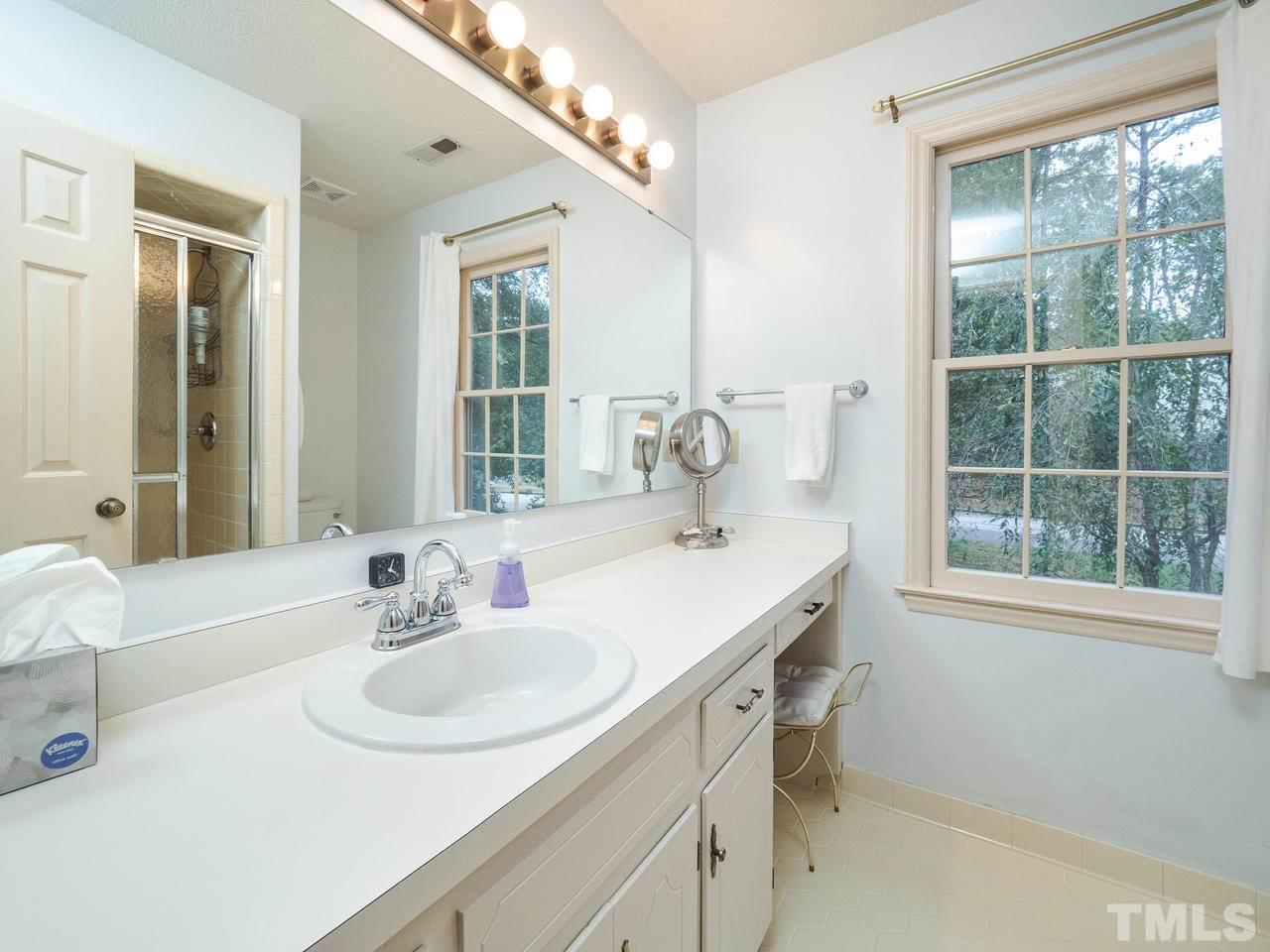7705 Valley Run Drive Raleigh, NC 27615 - Photo 19 of 27 a bathroom with a sink and a window