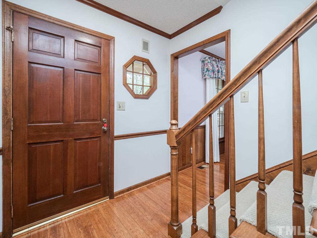 7705 Valley Run Drive Raleigh, NC 27615 - Photo 3 of 27 a view of staircase with wooden floor and staircase