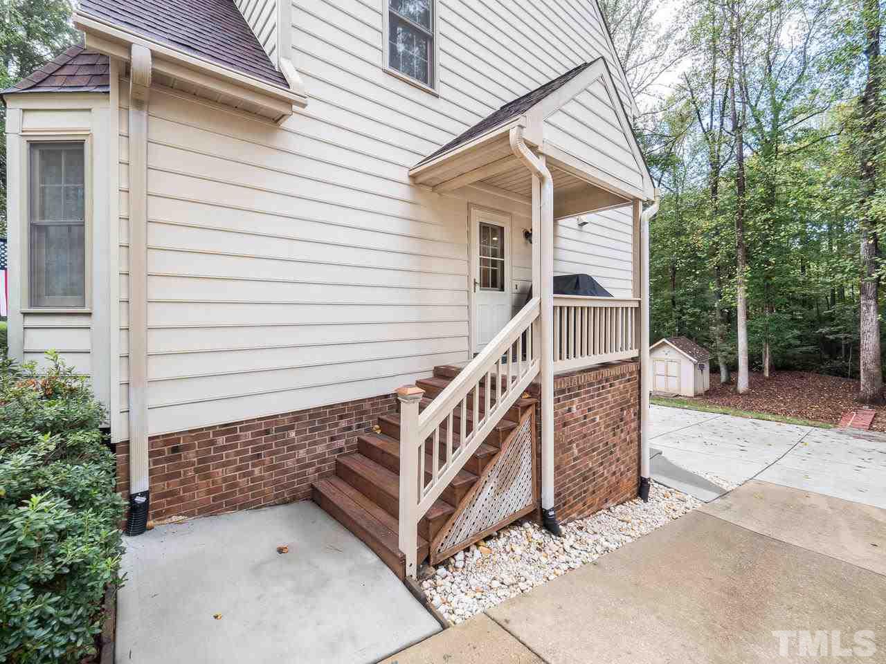 7705 Valley Run Drive Raleigh, NC 27615 - Photo 23 of 27 a view of a house with a small yard and wooden fence