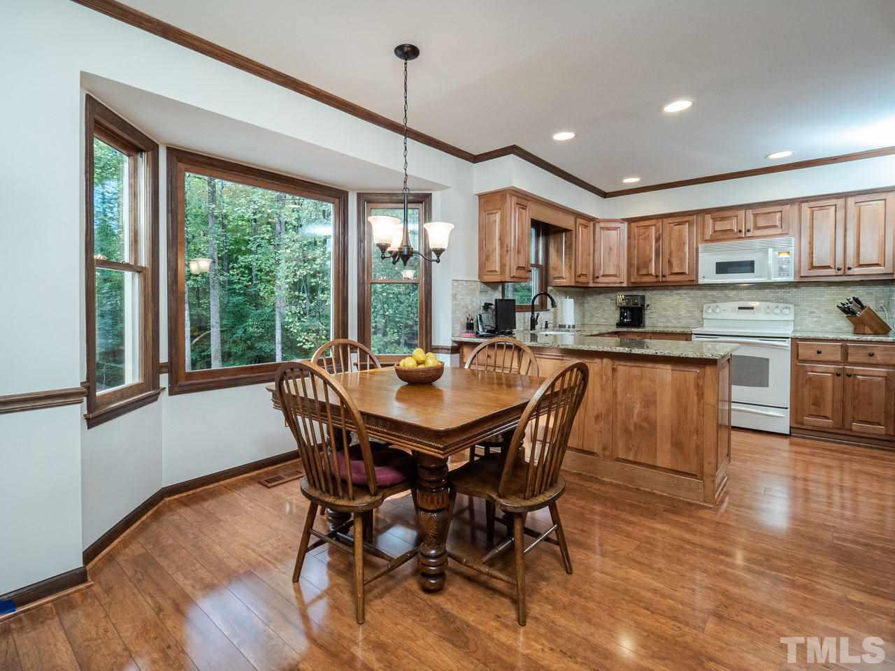 7705 Valley Run Drive Raleigh, NC 27615 - Photo 6 of 27 a view of a dining room with furniture window and wooden floor