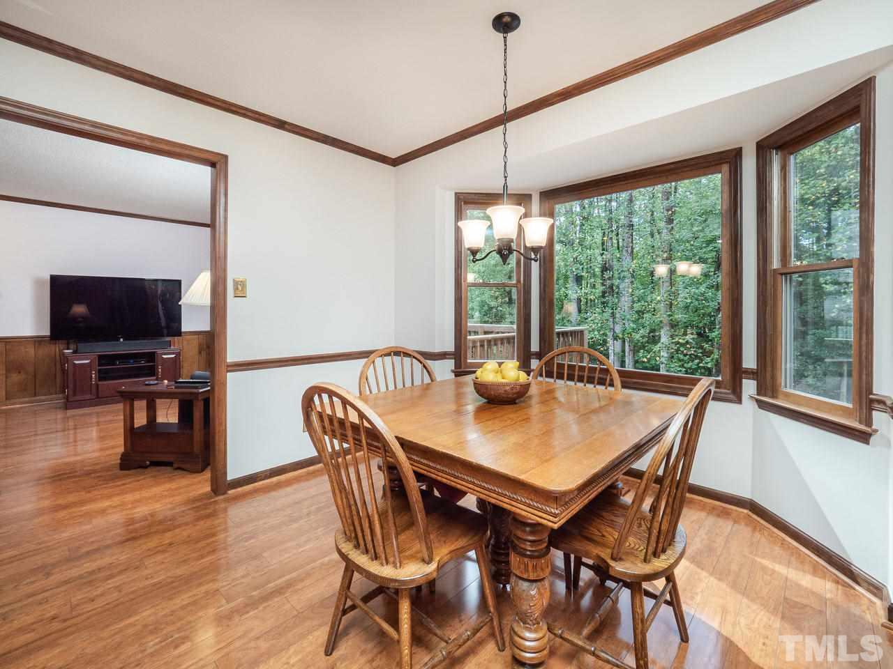 7705 Valley Run Drive Raleigh, NC 27615 - Photo 7 of 27 a view of a dining room with furniture window and wooden floor