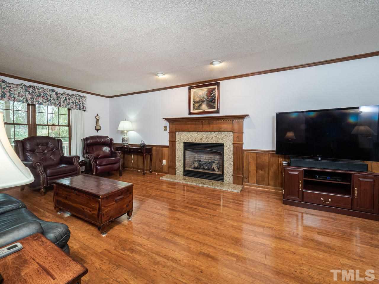7705 Valley Run Drive Raleigh, NC 27615 - Photo 9 of 27 a living room with furniture and a flat screen tv