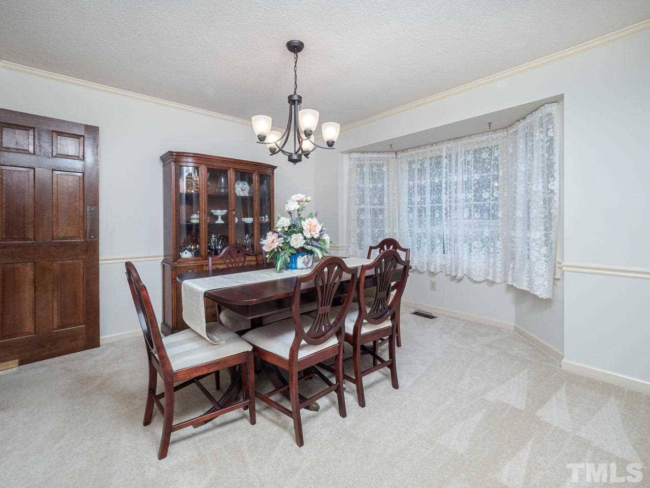 7705 Valley Run Drive Raleigh, NC 27615 - Photo 10 of 27 a view of a dining room with furniture window and outside view