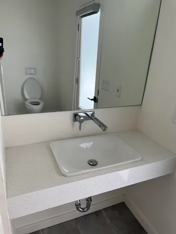 a view of a kitchen with a sink a stove and cabinets