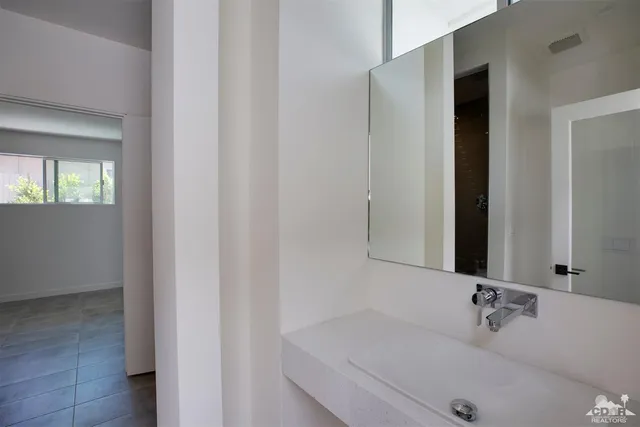 a bathroom with a tub and mirror