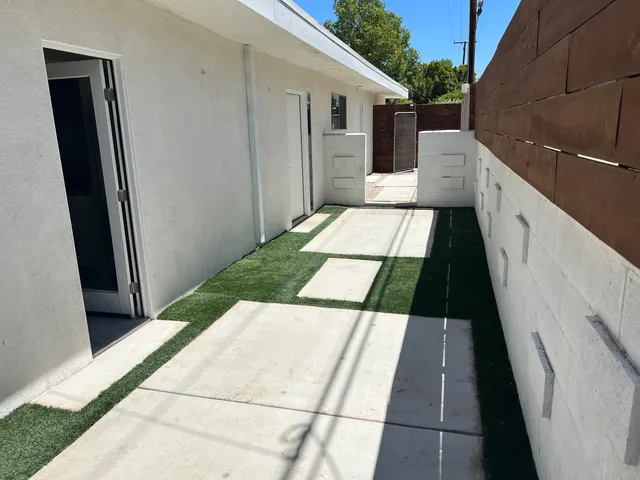 a kitchen with a sink a refrigerator and cabinets