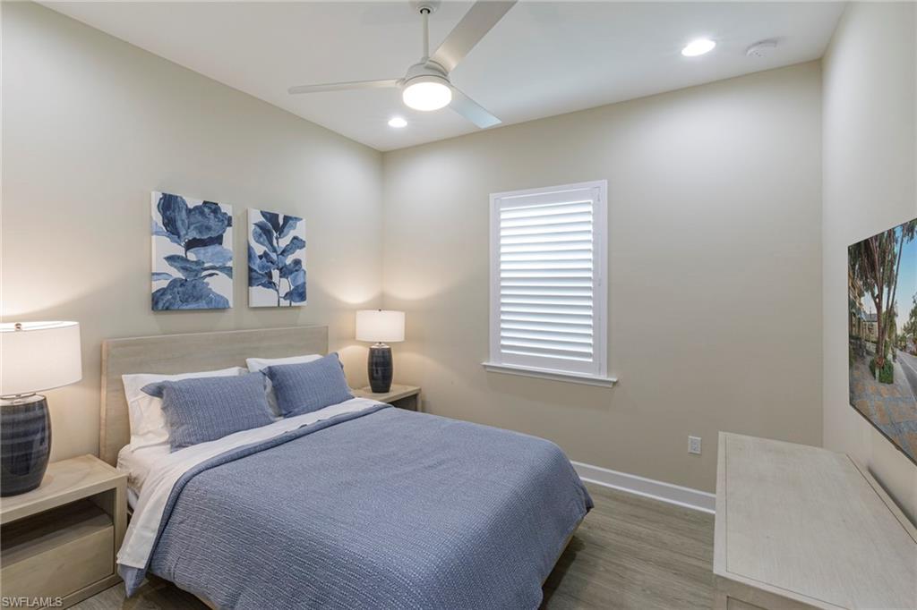 7184 Cayo Coco Lane Naples, FL 34113 - Photo 16 of 40 a bedroom with a bed and a window