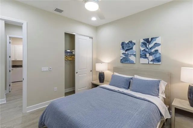 a bedroom with a bed and a painting on the wall