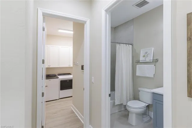 a bathroom with a toilet sink and a mirror