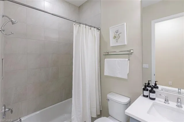 a bathroom with a toilet sink and shower